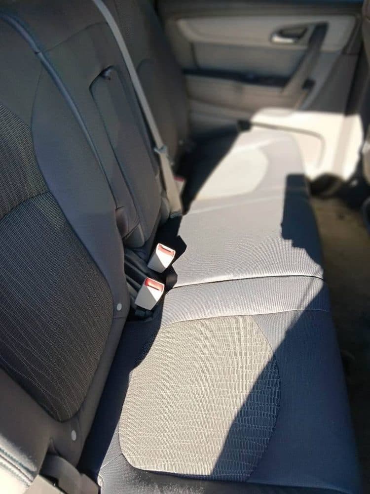 Clean gray fabric car rear bench seat after upholstery cleaning